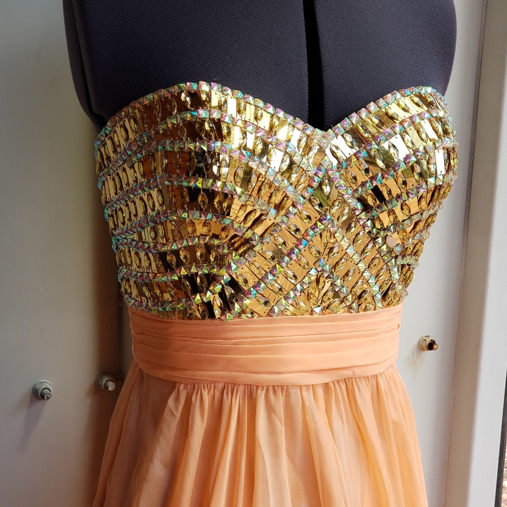 Peach and gold strapless prom dress.